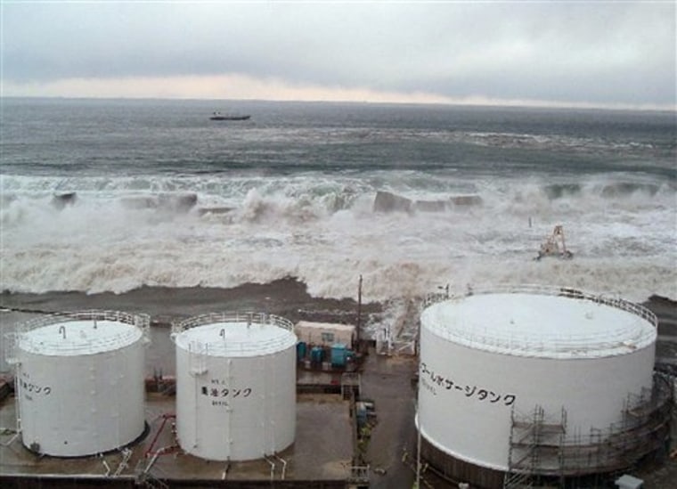 Waves of tsunami come toward tanks of heavy oil for the Unit 5 of the Fukushima Dai-ichi nuclear complex in Okuma, Fukushima Prefecture, Japan on March 11. 